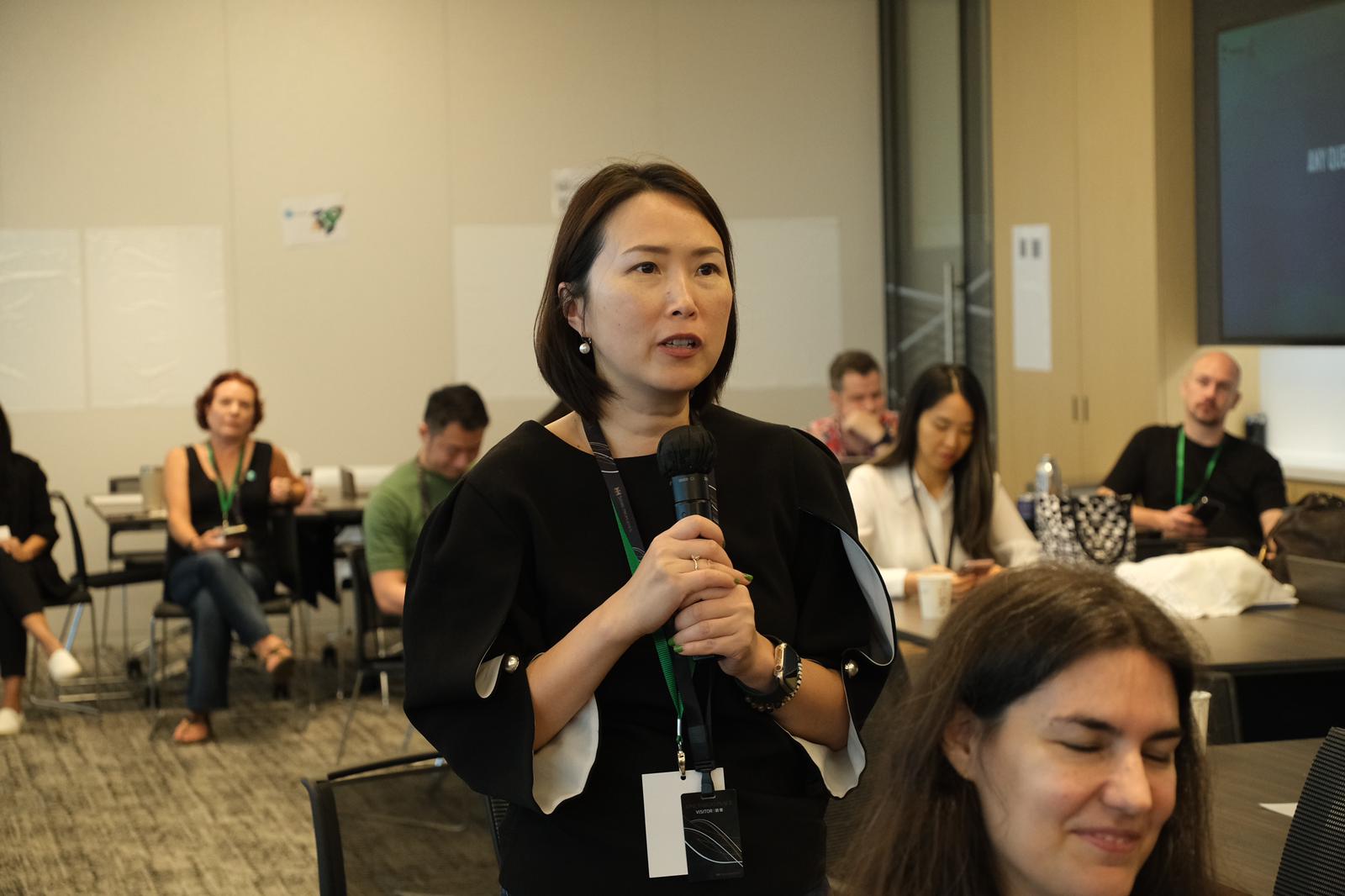 Heidi Spurrell speaking with microphone at UnConference facilitation session