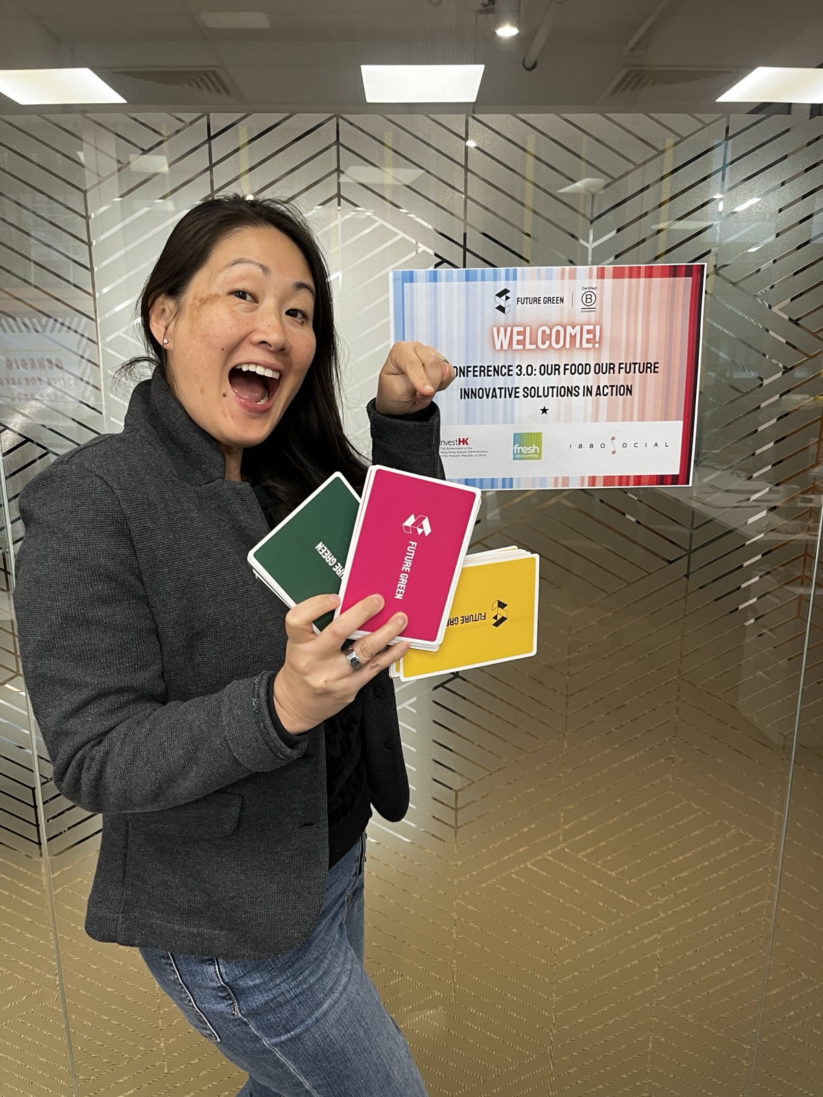 Heidi Spurrell excitedly holding Planet Possible cards — Future Green's sustainability game