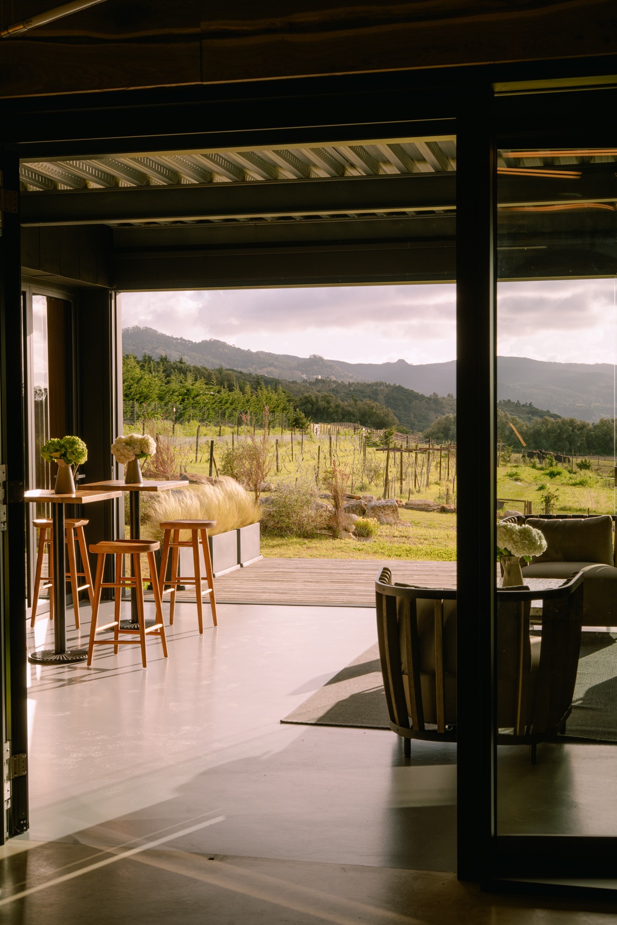 Indoor-outdoor terrace with vineyard views at golden hour